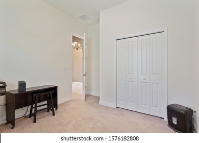 Ponte Vedra Beach, Florida / USA - November 29 2019: Empty Bedroom With Only A Small Desk And Paper Shredder In It