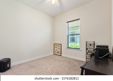 Ponte Vedra Beach, Florida / USA - November 29 2019: Empty Bedroom With Only A Small Desk And Paper Shredder In It