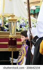 Pontevedra, SPAIN - APRIL 17, 2014: A Boy Dressed Acolyte Wait Between Hooded, To March In The Procession Of Holy Week.