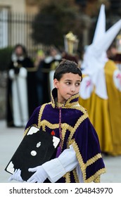 Pontevedra, SPAIN - APRIL 17, 2014: A Boy Dressed Acolyte Wait  To March In The Procession Of Holy Week.