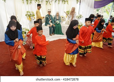 PONTIAN, JOHOR: MAY 2, 2015: A group of Malay youth  performs the zapin dance at the wedding ceremony on May 2, 2015. The zapin dance is performed at weddings and joyous celebrations.