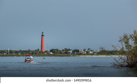 Pontoon Boat In The Ponce Inlet Waterway Travels Towards The Ponce De Leon Lighthouse In New Smyrna Beach, Florida.