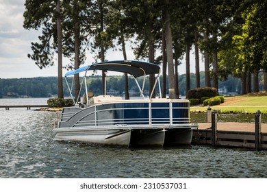 Pontoon boat at private dock on freshwater lake. - Powered by Shutterstock