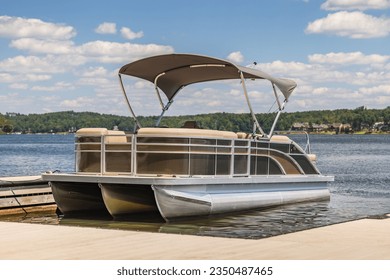 Pontoon boat at private marina dock on freshwater lake. - Powered by Shutterstock