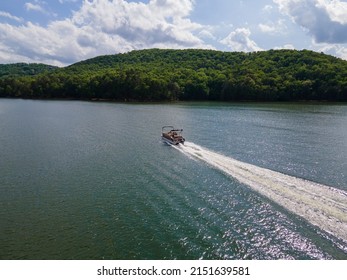 Pontoon Boat Traveling At Full Throttle Across Open Lake. Party Barge On Lake Altoona During The Summer.