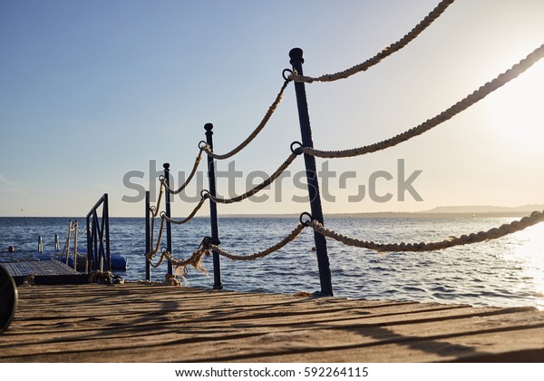 pontoon with rope barriers\
in the sea