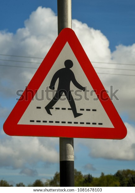 PONTYPRIDD, WALES - APRIL\
2018: Road sign in a car park warning drivers of pedestrians\
crossing the road