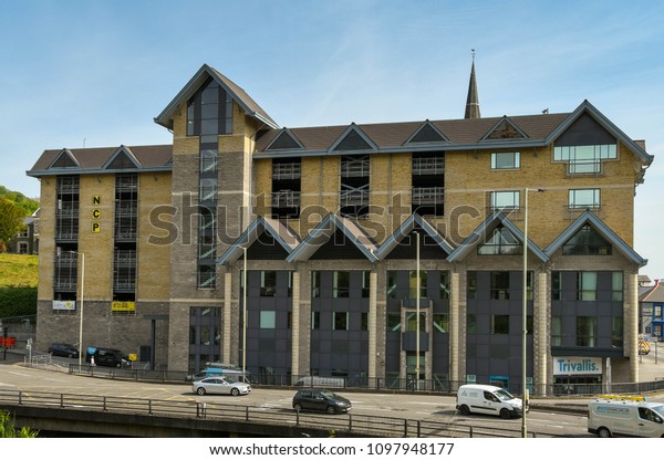 PONTYPRIDD,\
WALES - MAY 2018: Wide angle view of the offices of Trivallis\
housing association in Mill Street, Pontypridd. Part of the\
building is a public multistorey car\
park
