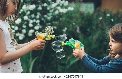 Pony, Dinosaur Soap Bubble Gun Shooter, Blower. Battle, Party For Kids. Girls,chidren Playing Funny Family Game With Sister,girl. Outdoors Activity In Summer In Green Park. Big Flying Bubbles.