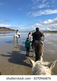 Pony Trekking On A Donegal Beach In Ireland