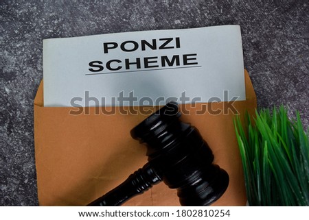 Ponzi Scheme text with document brown envelope and gavel isolated on office desk.