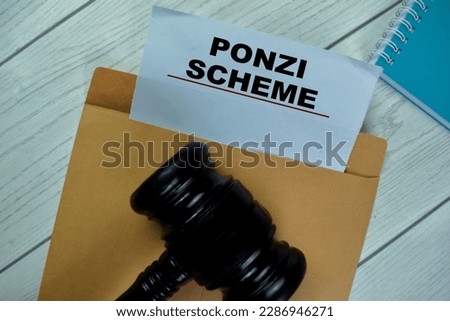 Ponzi Scheme text with document brown envelope and gavel isolated on office desk