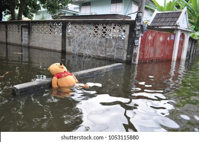 A Pooh Teddy Bear Is Drowning In A Flooded Street Of Bangkok, Thailand In October 2011