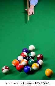 Pool Balls Being Broken By A Player Whose Hand And Cue Is Visible