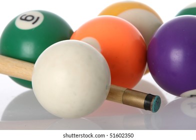 Pool balls and end of cue with reflection