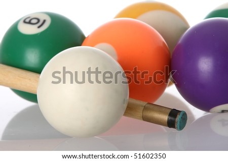 Pool balls and end of cue with reflection