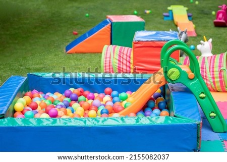 Pool of balls and games for a children's party in the garden of a house, for birthdays.