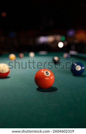 Pool balls on a billiards table in a bar. 