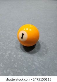 Pool balls on gray table sport game set known as eight ball pool. Number one.