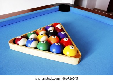 Pool balls in the triangular frame. On the pool table.