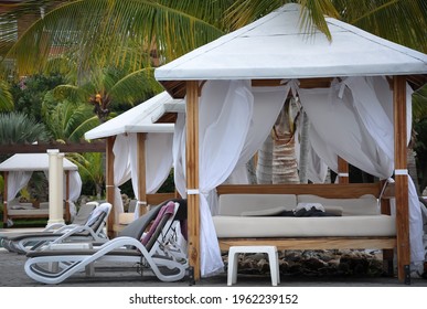 Pool Beds And Cabana Under Coconut Trees