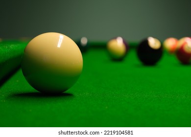 Pool, Billiard, Snooker Balls From A Low Angle On Soft Green Textured Table. For A Dynamic Design Element On A Wallpaper, Background, Banner, Poster At A Party, Club, Bar Or Pub.