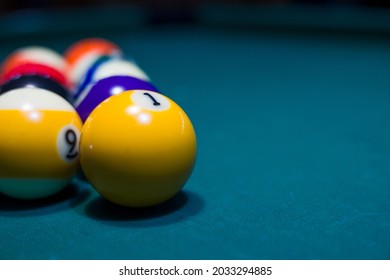 pool or billiards balls on  blue table . focus on the ball number 1