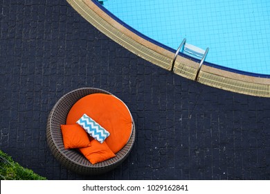 Pool Chair On Black Tiles Floor Beside Swimming Pool