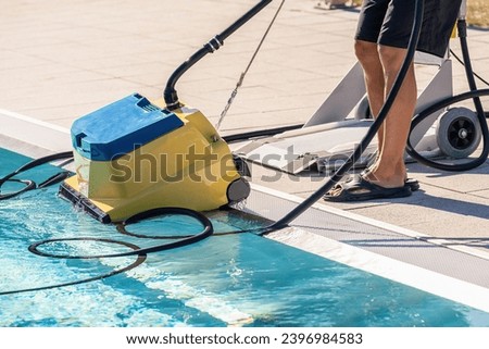 Similar – Image, Stock Photo Pool cleaning robot being placed by a person next to a swimming pool