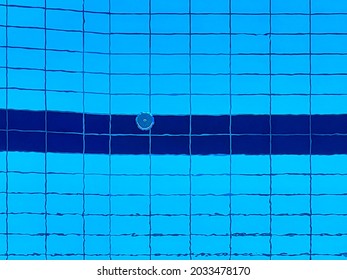 Pool With Clear Water And Blue Color Tinted Tiles. Detail With No People