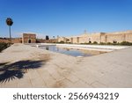 Pool in courtyard of El Badi palace in African MARRAKESH city in MOROCCO, clear blue sky in 2023 warm sunny winter day on January.