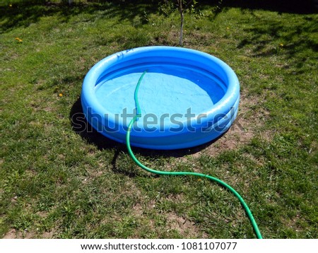 The pool is filled with water inflatable round blue