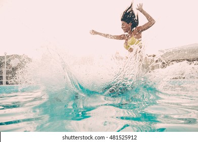 Pool fun. Beautiful young woman jumping into the outdoor swimming pool  - Powered by Shutterstock