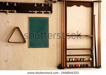 Pool hall wall with pool rack, chalk board, pool cues and pool balls 
