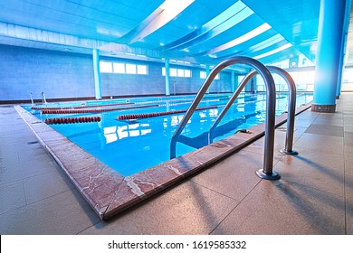 Pool ladder with stairs in empty pool for sport swimming training in leisure center