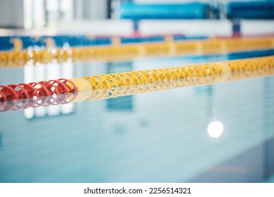 Pool, lanes in water for competition or racing lines for fitness or underwater sports empty with reflection. Exercise, workout and fresh, clear swim training arena lanes for swimming race with nobody - Shutterstock ID 2256514321