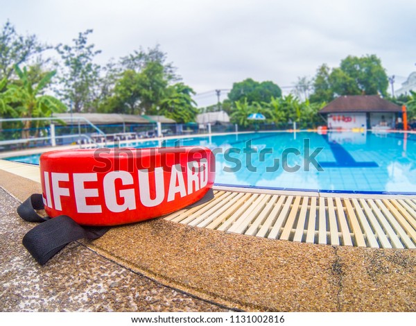 pool\
lifeguards red rescue tube near swimming pool\
