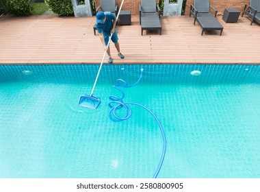Pool maintenance with scoop net  and automatic robot cleaner.