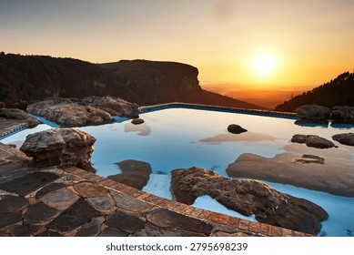 A pool on a cliff overlooking the lower part of the reserve near the God's Window viewpoint in the Drakensberg Mountains during sunrise
