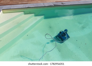 pool robot cleaning a dirty swimming pool - Powered by Shutterstock