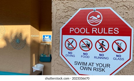 Pool Rules Sign On Post In Backyard Home