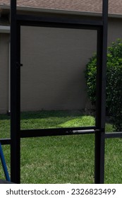 Pool screen loose flapping in wind that needs repair due to heavy wind hurricanes hail and rain