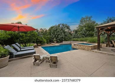 a pool at sunset with lounge chairs  - Powered by Shutterstock