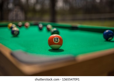 Pool Table Outside With Unlucky 13 Ball As The Focus.  