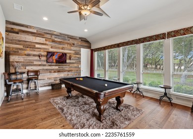 A pool table in a room with big windows - Shutterstock ID 2235761559