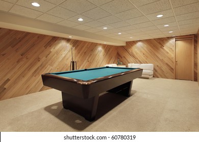 Pool Table In Suburban Home With Wood Paneling