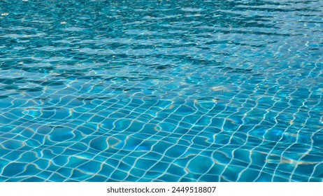 pool water under the sunlight with blue mosaic, swimming pool surface - Powered by Shutterstock