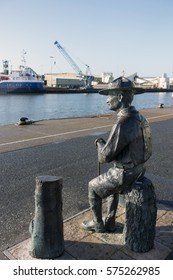 POOLE QUAY, DORSET, UK:FEBRUARY 7 2017: Bronze Statue Of Lord Baden Powell Overlooks The Harbor, Lord Baden Powell Founded The Boy Scouts Organization.