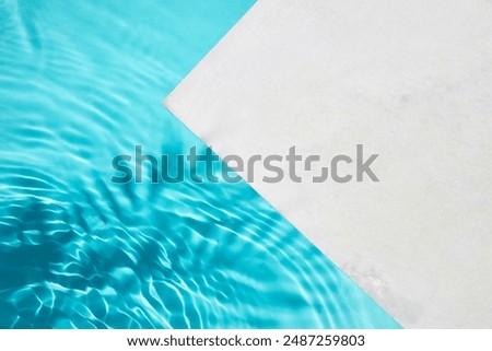 Poolside Calm. A serene image showcasing a clean pool with crystal blue water and a white poolside.