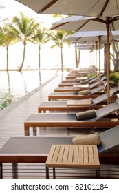 Poolside Loungers At An Exotic Asian Hotel.